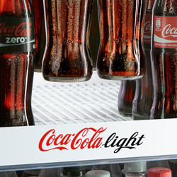 coca-cola light bottles floating in the air